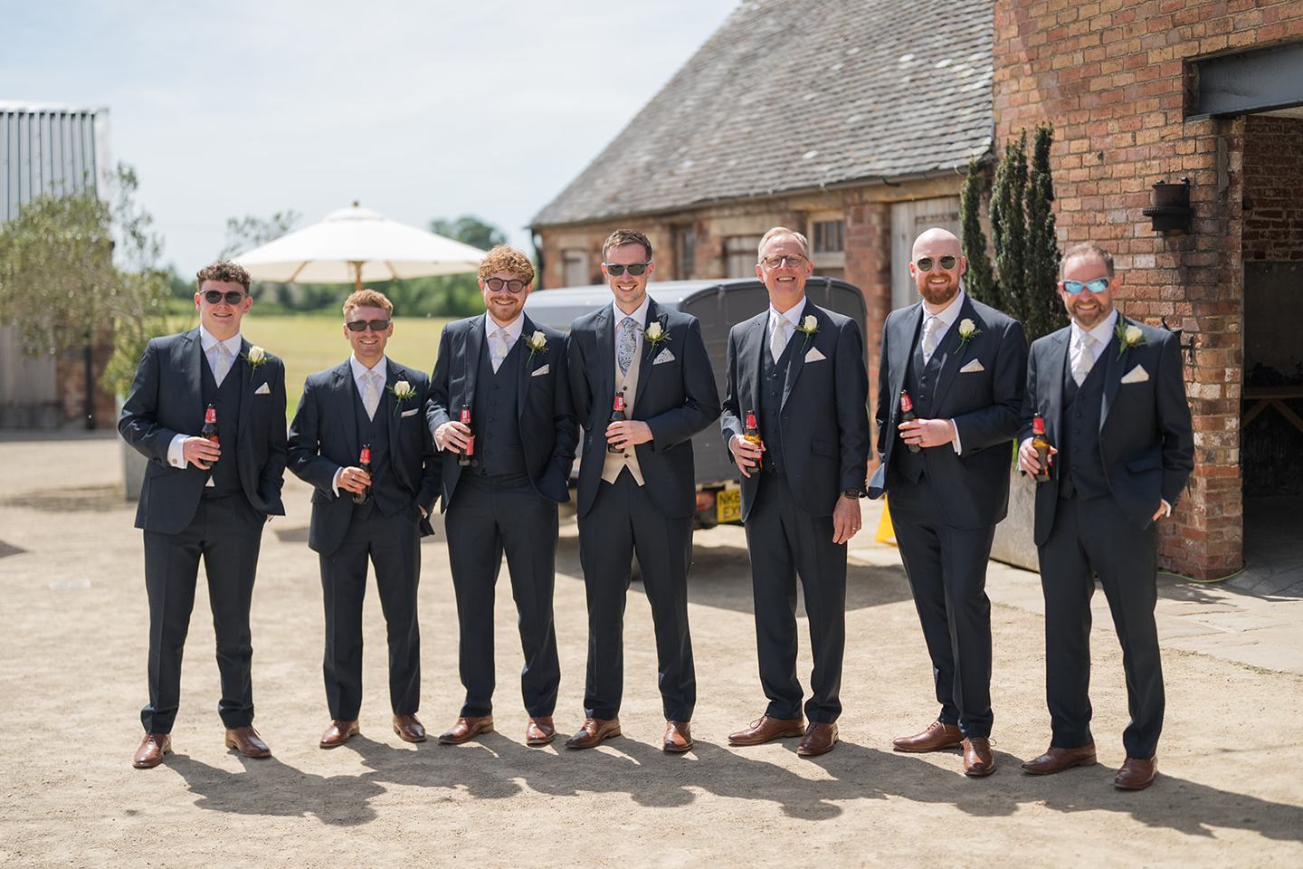 Groomsmen outside the barn at Emma and Jack’s Grangefields wedding
