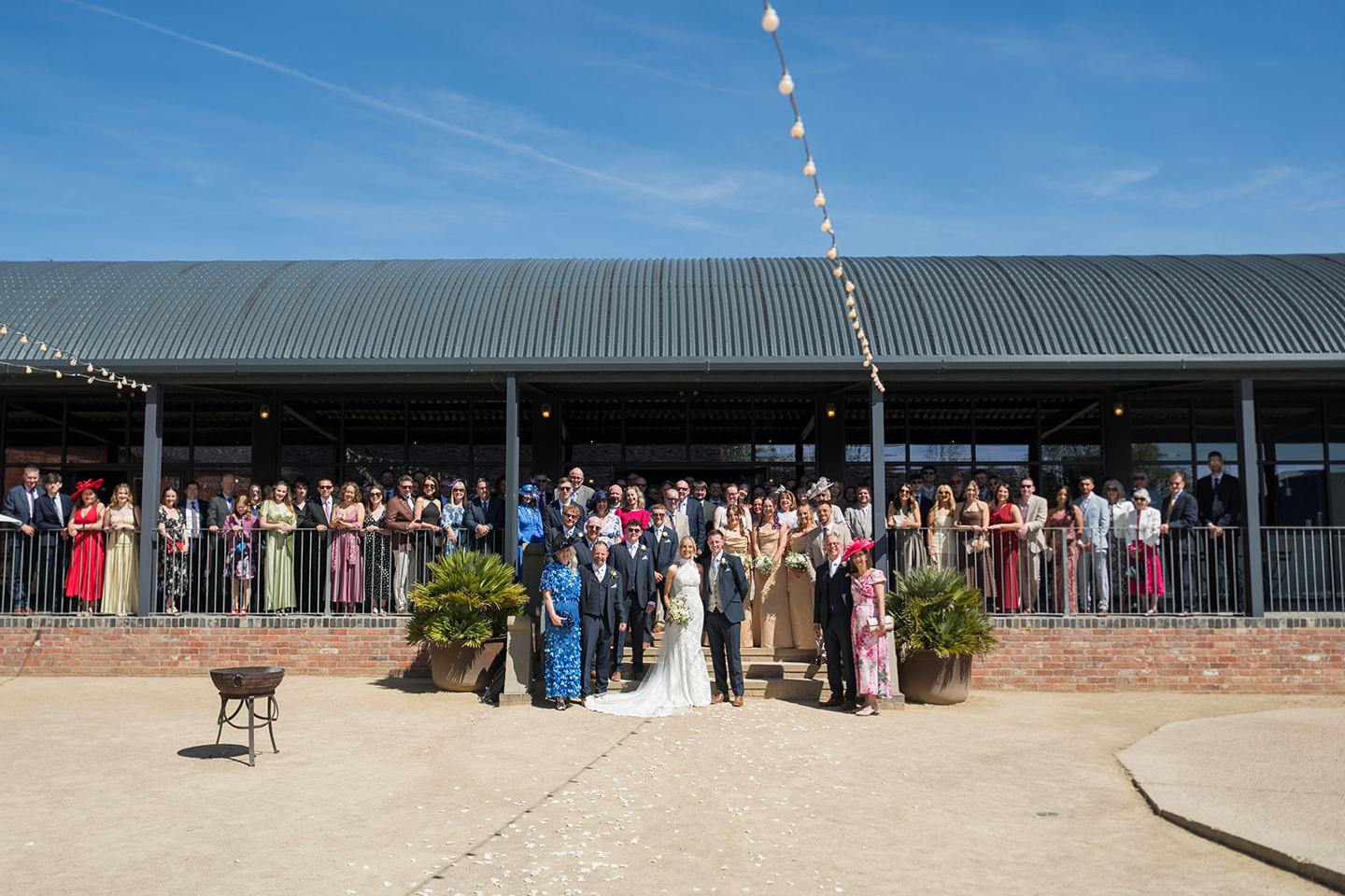 Wedding guests in the courtyard at Emma and Jack’s Grangefields wedding