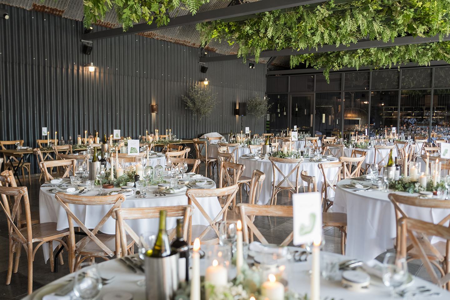 Reception tables dressed for dinner at Emma and Jack’s Grangefields wedding