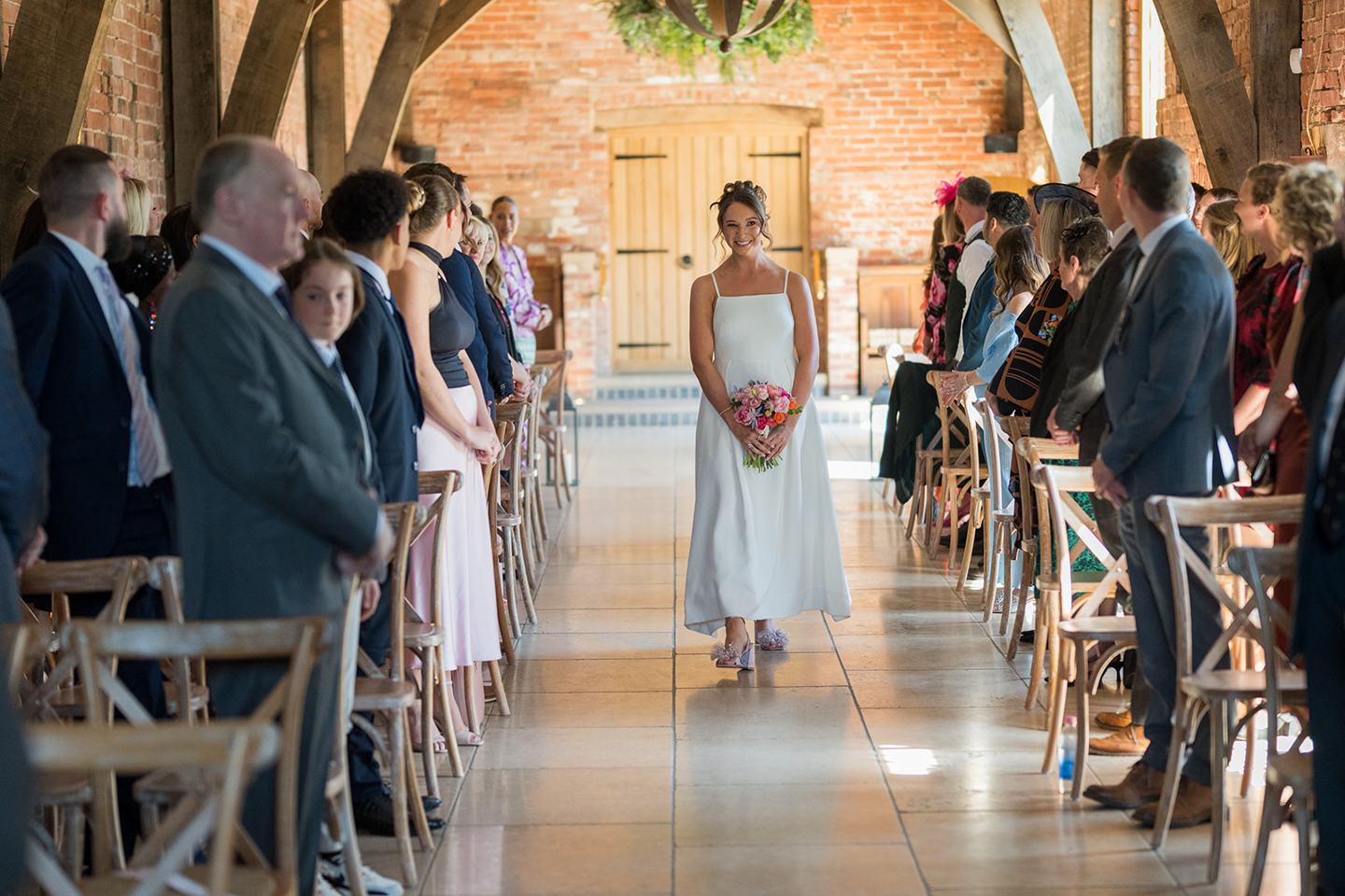 Bride walking down the aisle at Georgie and Matt’s Grangefields wedding