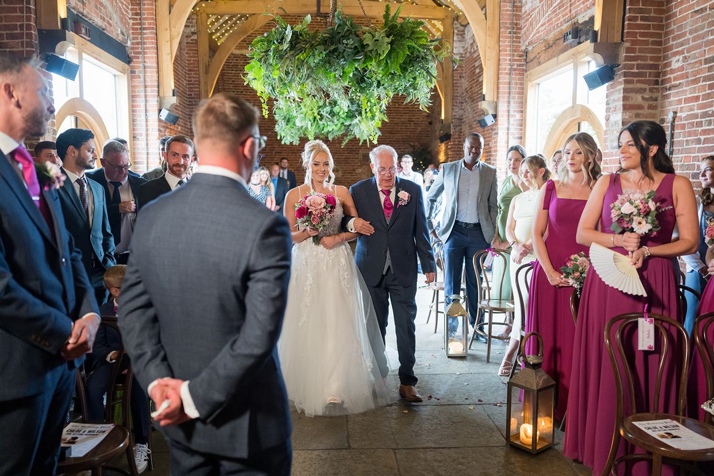 Bride walking down the aisle at Chloe and Wilson’s Hazel Gap Barn wedding