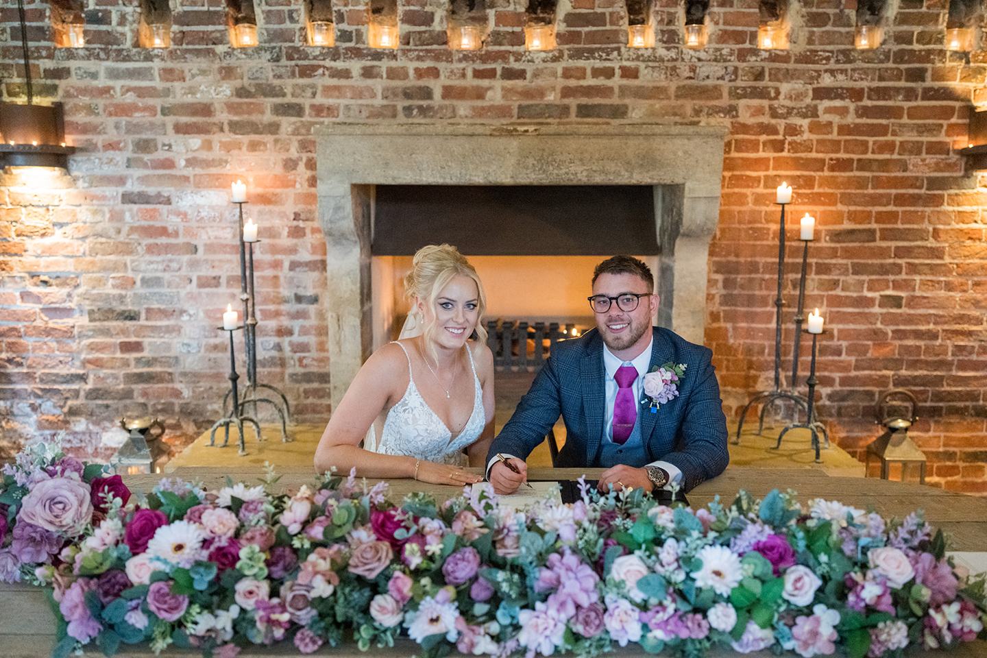 Signing the register at Chloe and Wilson’s Hazel Gap Barn wedding