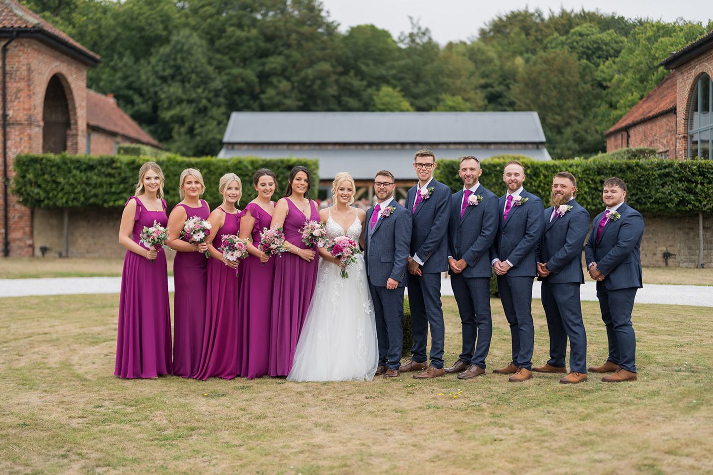 Wedding party in the grounds at Chloe and Wilson’s Hazel Gap Barn wedding