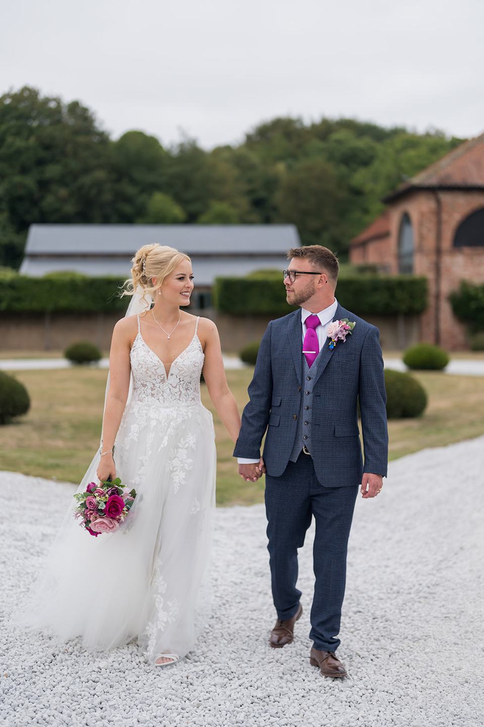 Newlyweds walking together at Chloe and Wilson’s Hazel Gap Barn wedding