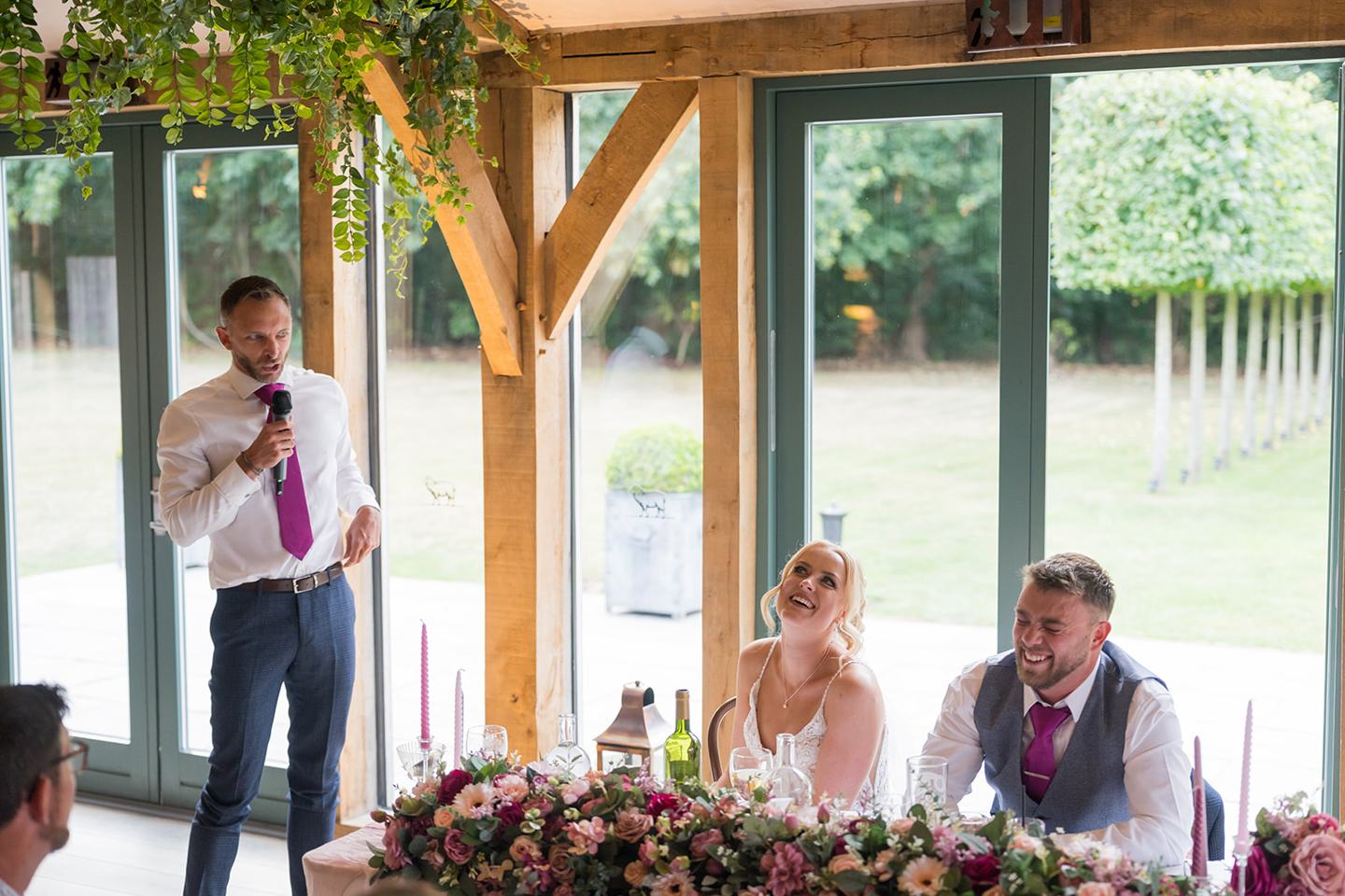 A speech in the reception room at Chloe and Wilson’s Hazel Gap Barn wedding