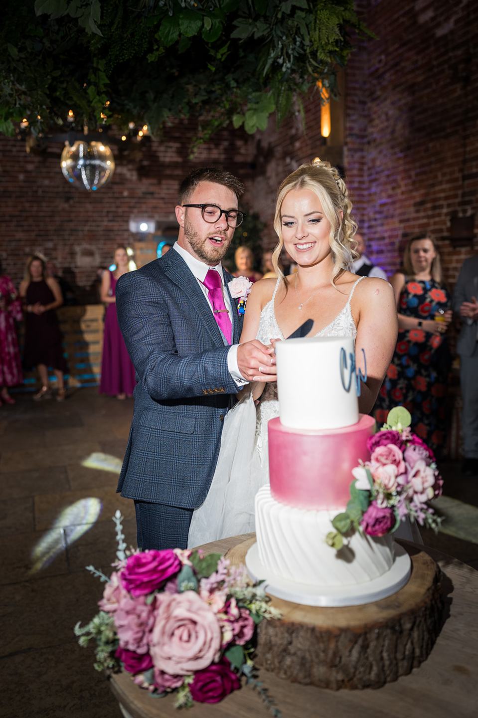 Cutting the cake at Chloe and Wilson’s Hazel Gap Barn wedding