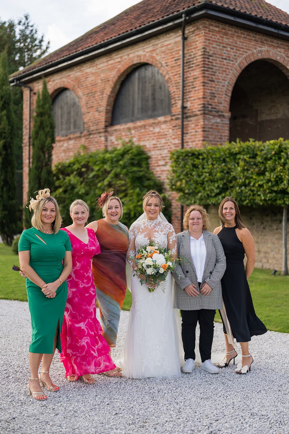 Family photograph beside the barn at Emma and Sam’s Hazel Gap Barn wedding