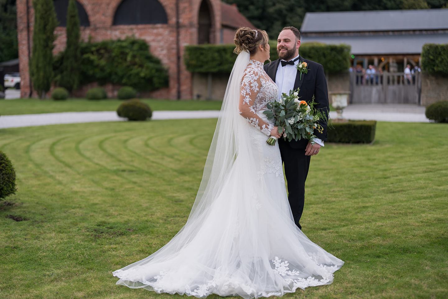 Newlyweds in the courtyard at Emma and Sam’s Hazel Gap Barn wedding