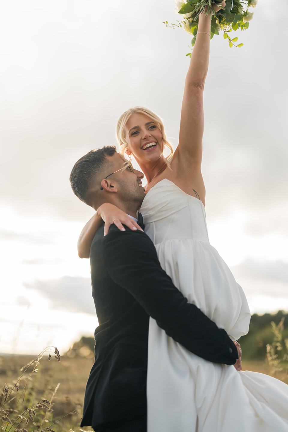 Celebrating together in the meadow at Mia and Herman’s Healey Barn wedding