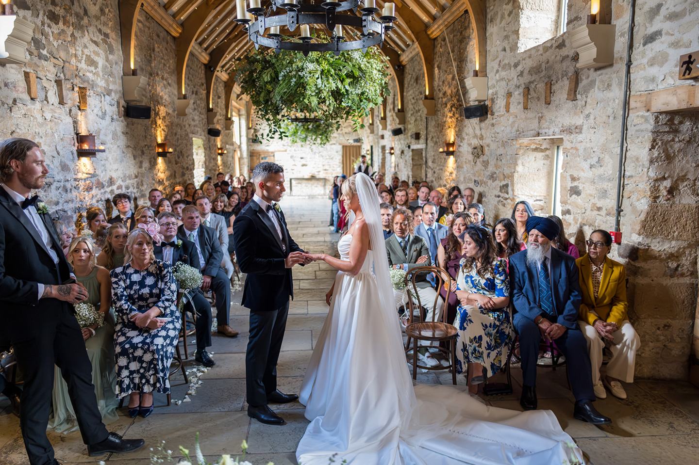 Wedding ceremony beneath the timber beams at Mia and Herman’s Healey Barn wedding