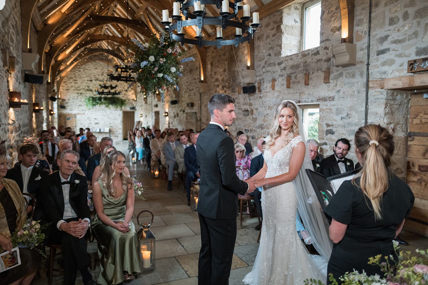 Wedding ceremony beneath the timber beams at Sophie and Sam’s Healey Barn wedding