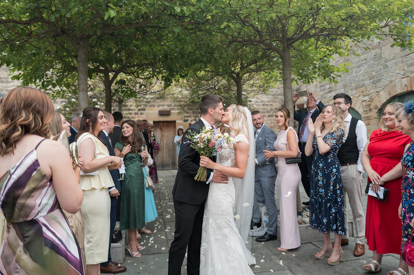 Guests in the courtyard at Sophie and Sam’s Healey Barn wedding