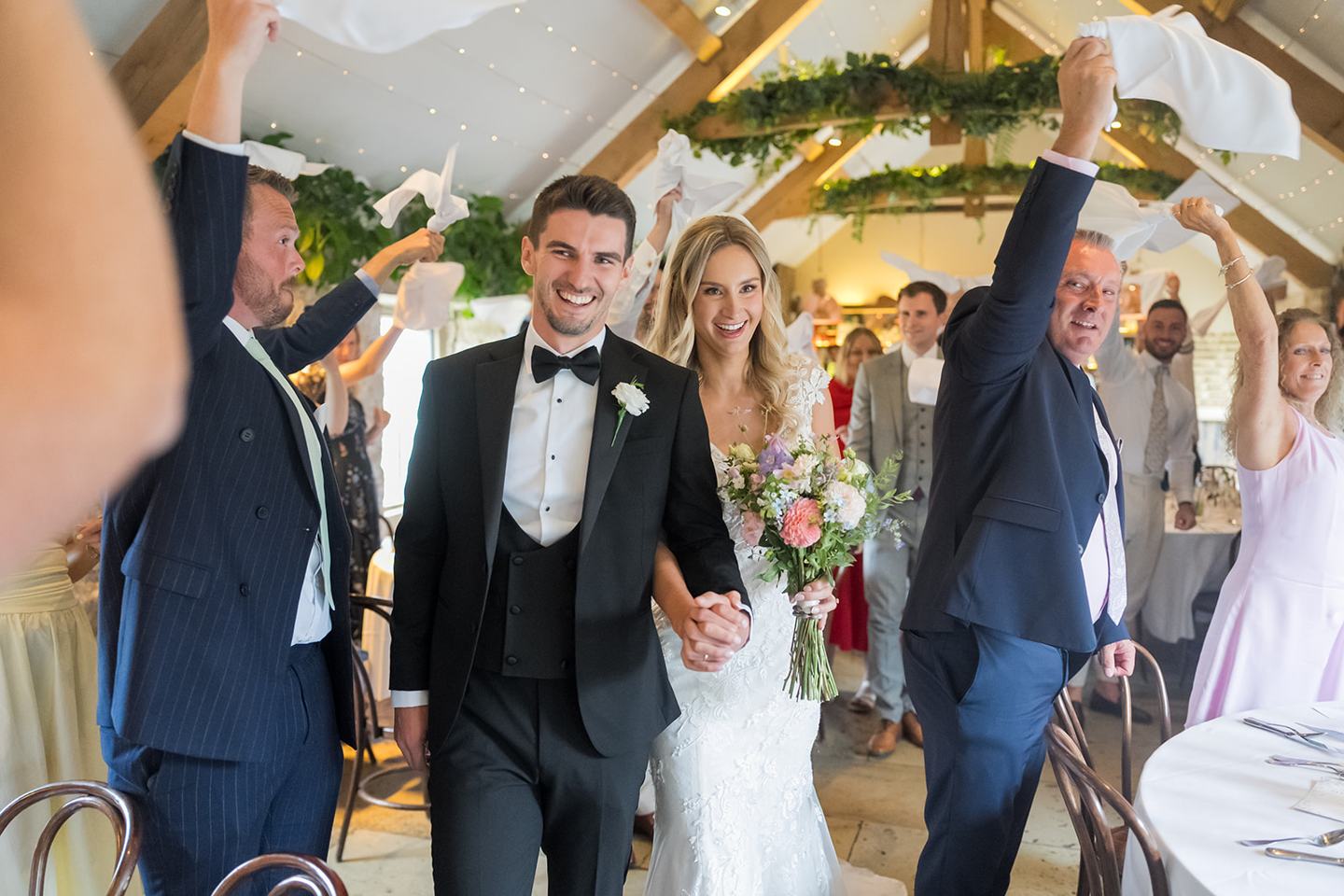 Entering the wedding breakfast at Sophie and Sam’s Healey Barn wedding