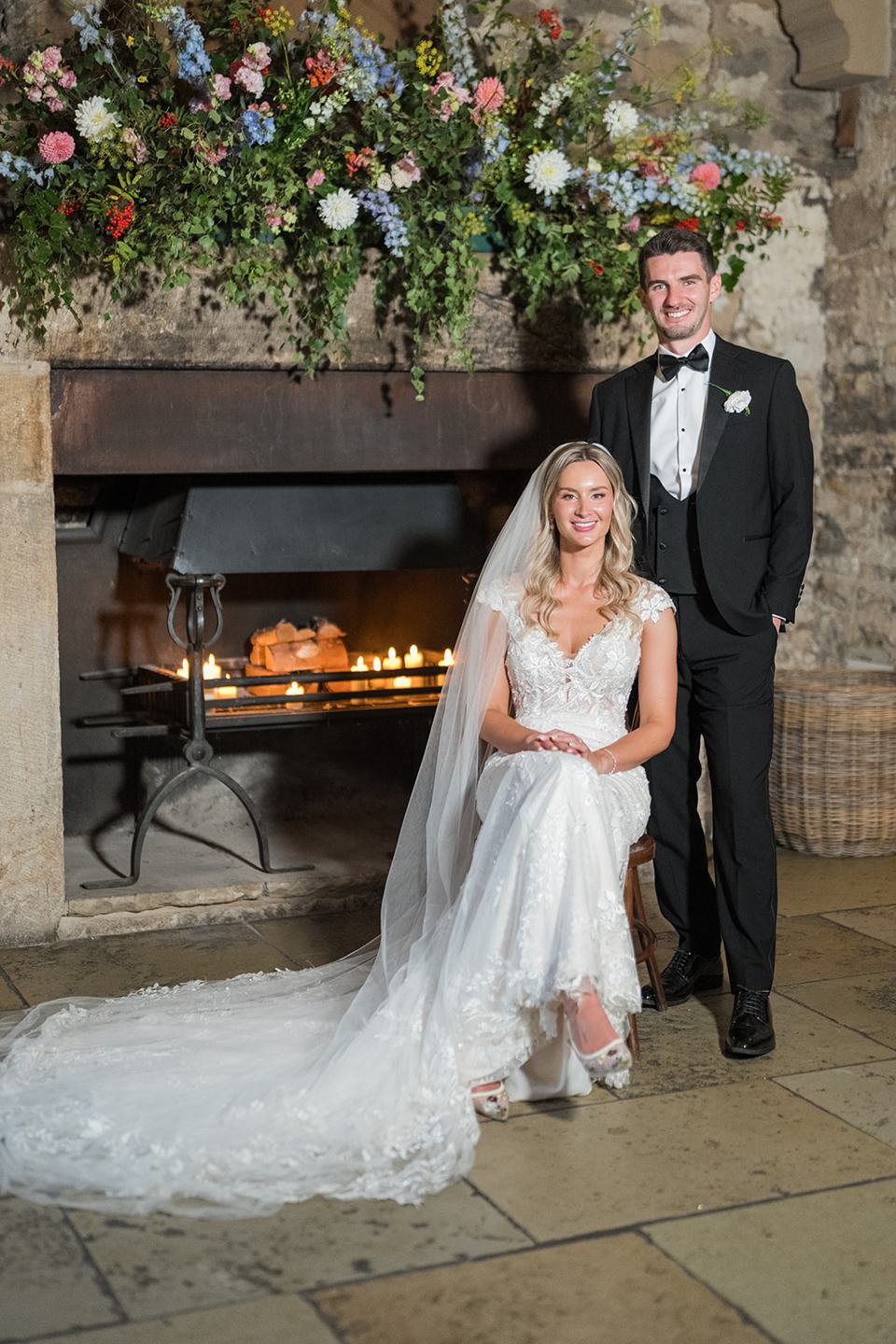 Portrait beside the fireplace at Sophie and Sam’s Healey Barn wedding
