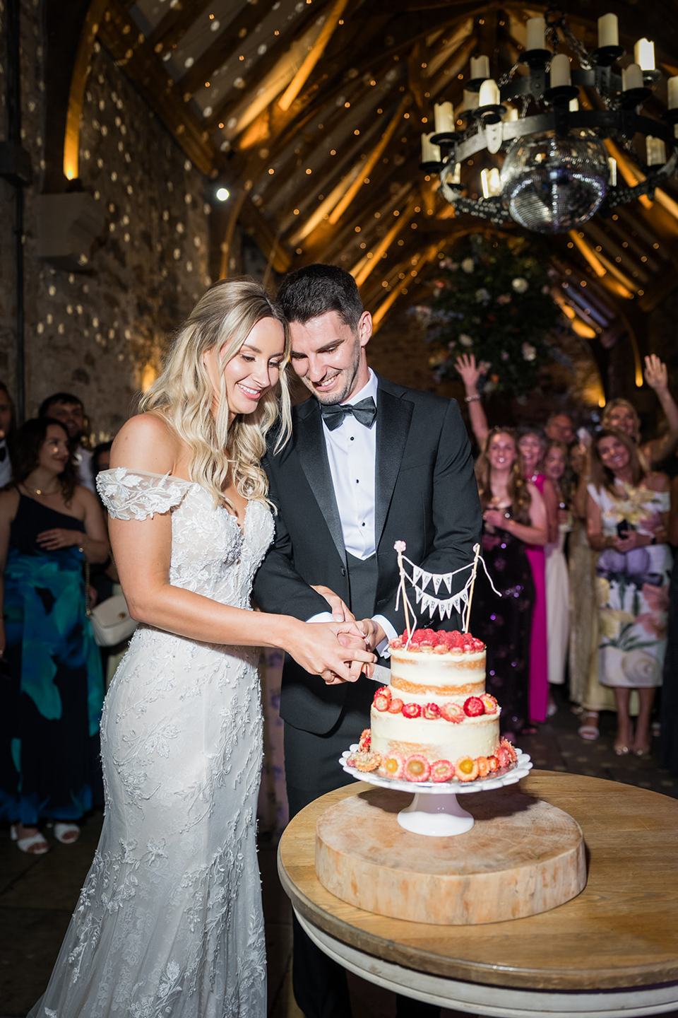 Cutting the cake at Sophie and Sam’s Healey Barn wedding