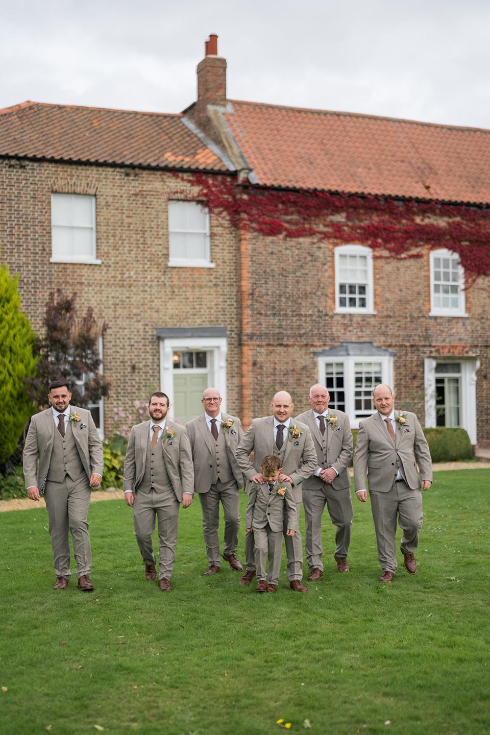Groom and friends outside Hornington Manor at Sally and Callum’s Hornington Manor wedding