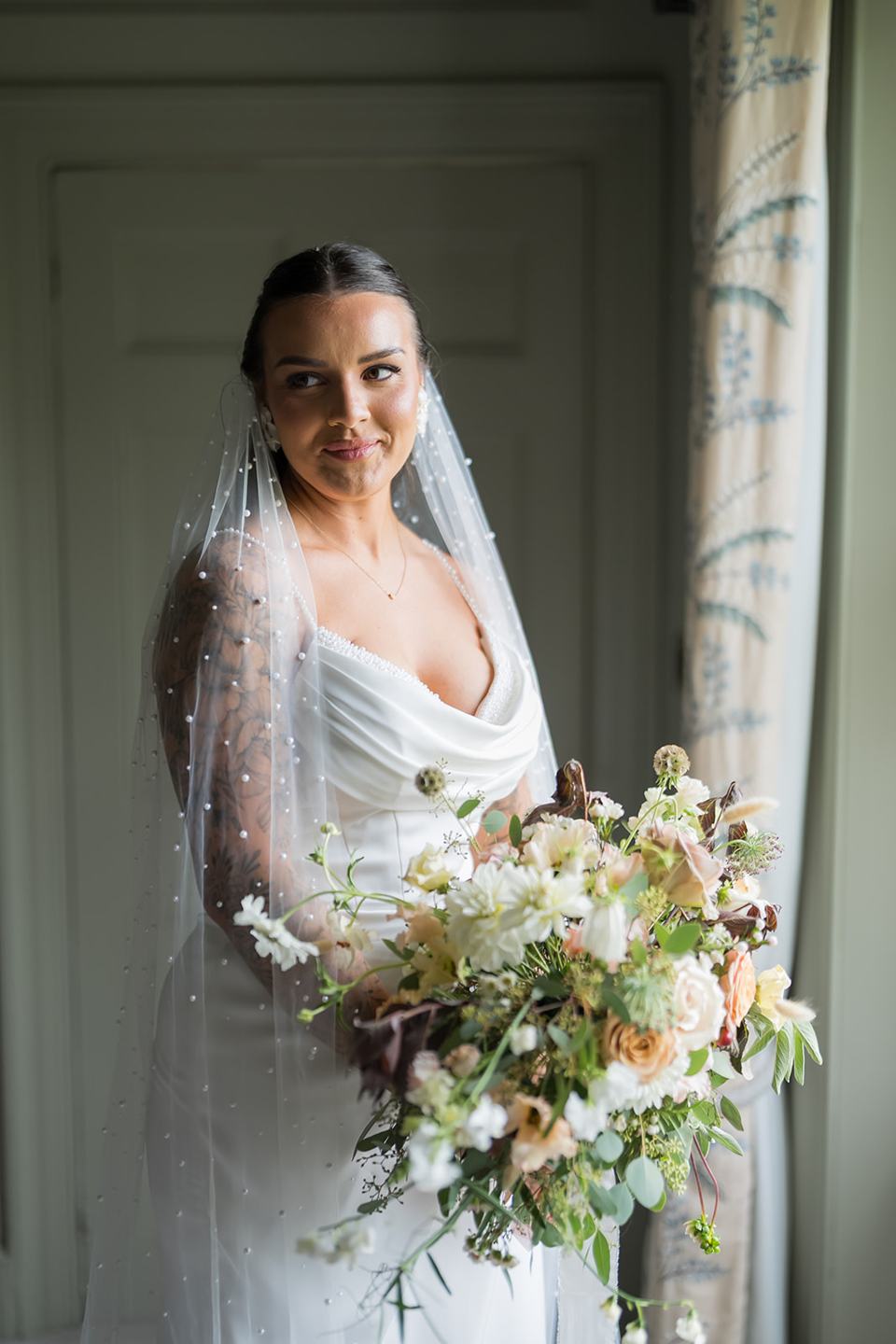 Bridal portrait by the window at Sally and Callum’s Hornington Manor wedding