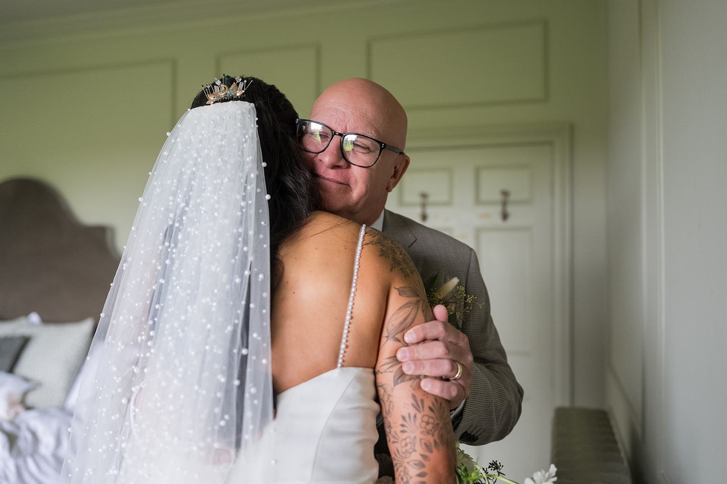 Bride greeting her father at Sally and Callum’s Hornington Manor wedding