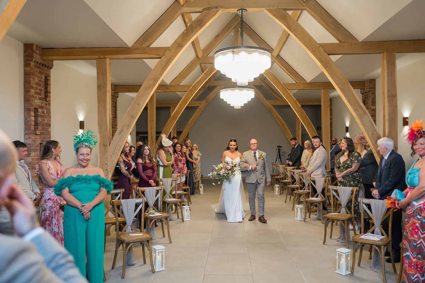 Wedding ceremony in the barn at Sally and Callum’s Hornington Manor wedding