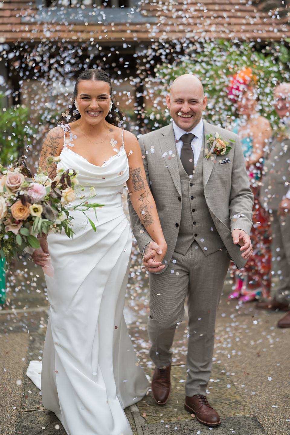 Confetti outside the barn at Sally and Callum’s Hornington Manor wedding