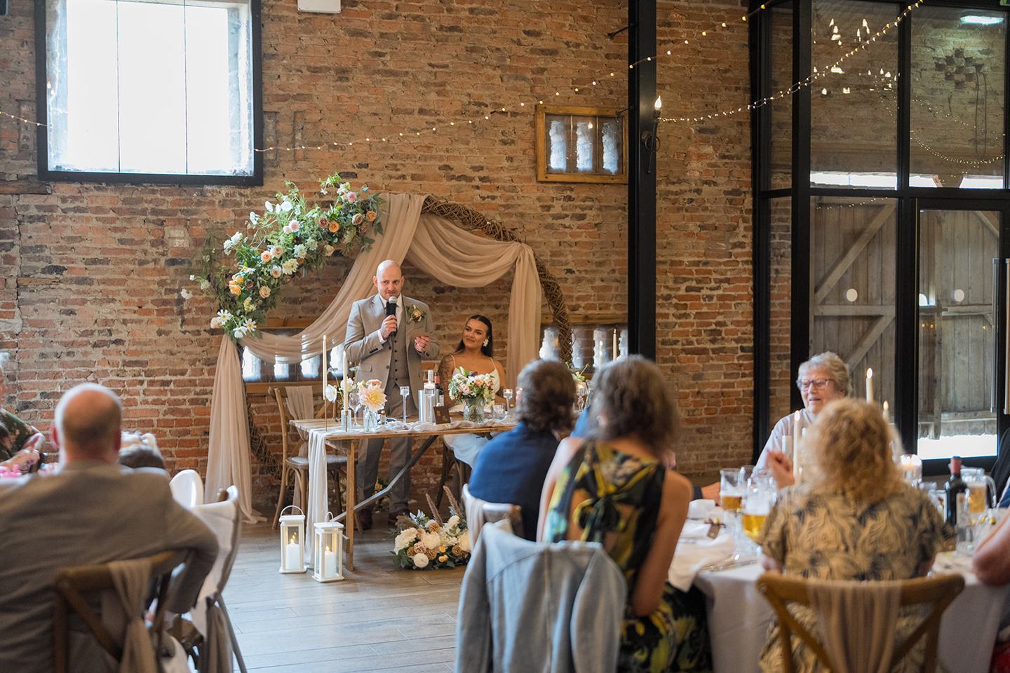 Wedding speeches in the barn at Sally and Callum’s Hornington Manor wedding