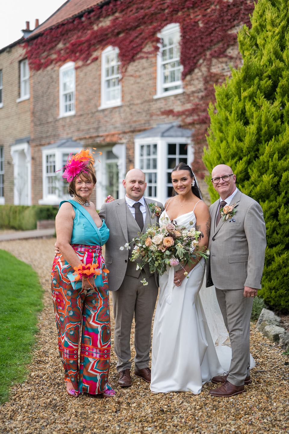 Family photographs outside the manor at Sally and Callum’s Hornington Manor wedding