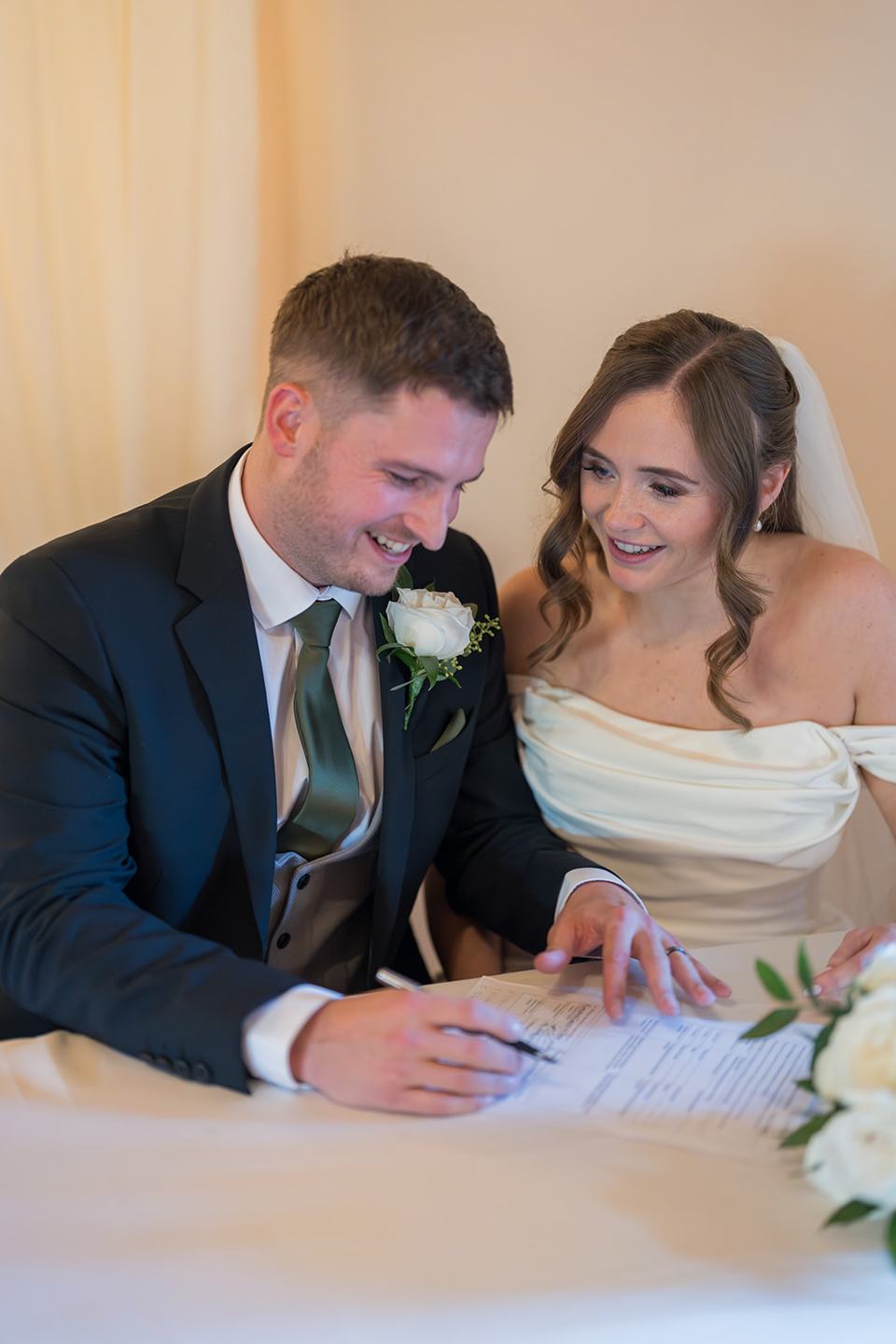 Signing the register at Harriet and Gareth’s Hyde Bank Farm wedding