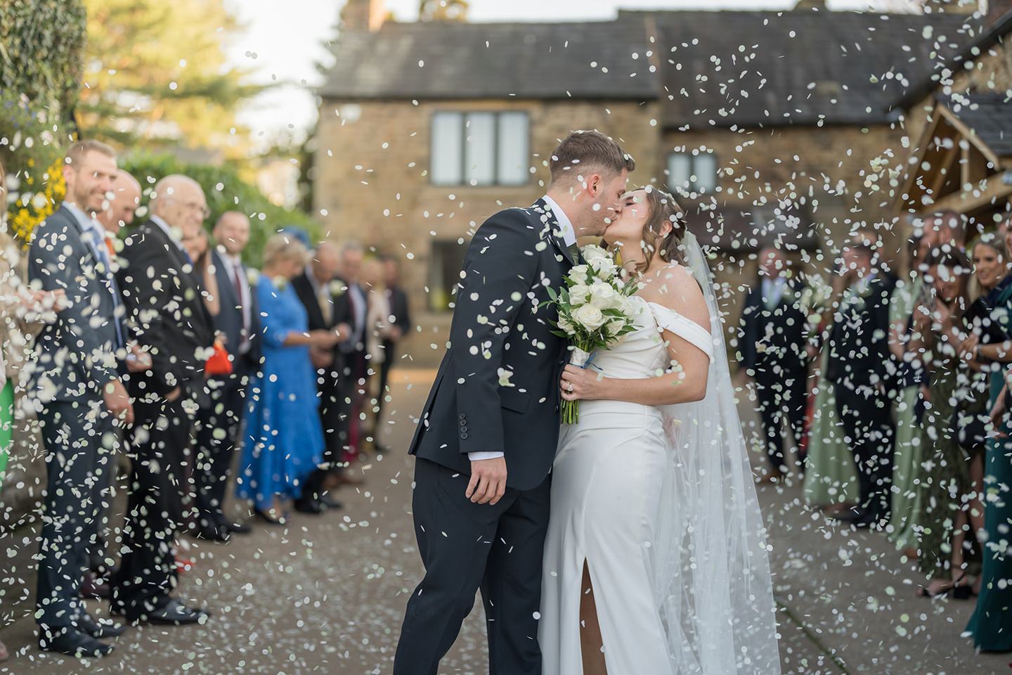 Confetti outside the barn at Harriet and Gareth’s Hyde Bank Farm wedding