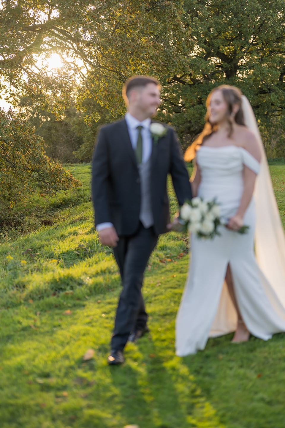 Couple walking in the grounds at Harriet and Gareth’s Hyde Bank Farm wedding