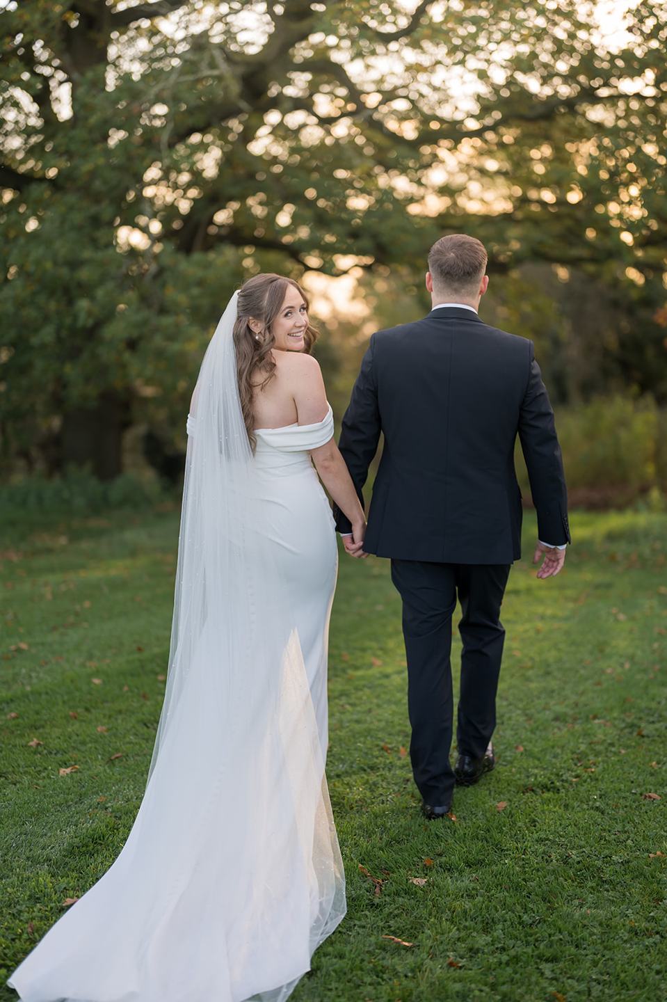 Newlyweds enjoying the gardens at Harriet and Gareth’s Hyde Bank Farm wedding