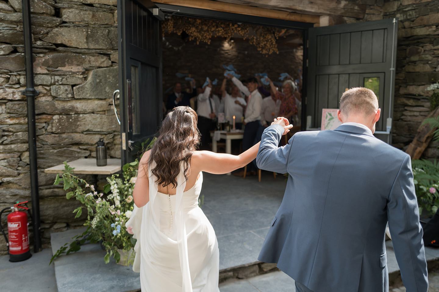 Couple entering the reception at Alex and Dan’s Lancrigg wedding