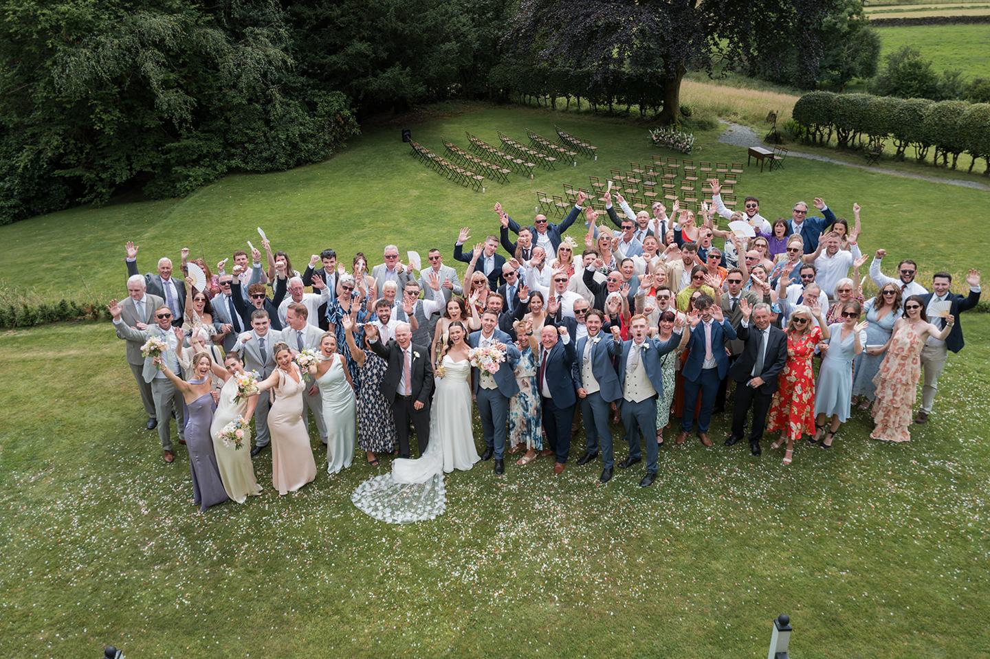 Wedding guests on the lawn at Alex and Dan’s Lancrigg wedding