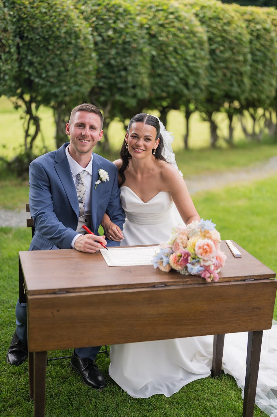 Signing the register at Alex and Dan’s Lancrigg wedding
