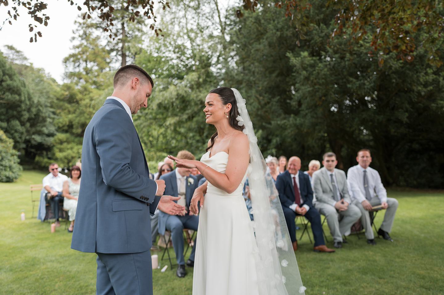 Couple exchanging vows outdoors at Alex and Dan’s Lancrigg wedding