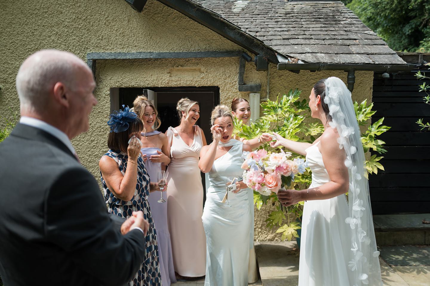 Bride greeting her father at Alex and Dan’s Lancrigg wedding