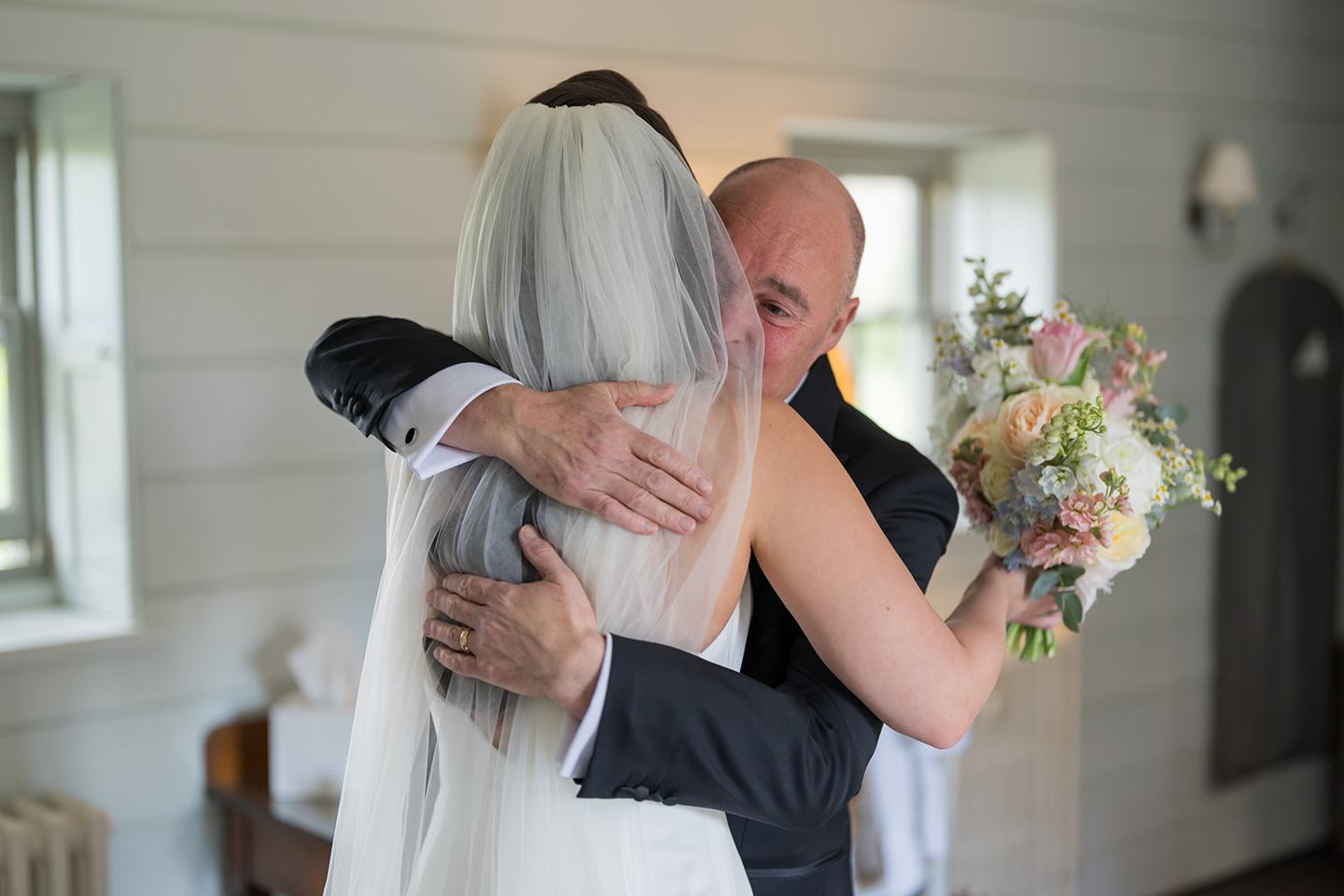 Bride greeting her father at Becky and Alex’s Middleton Lodge wedding