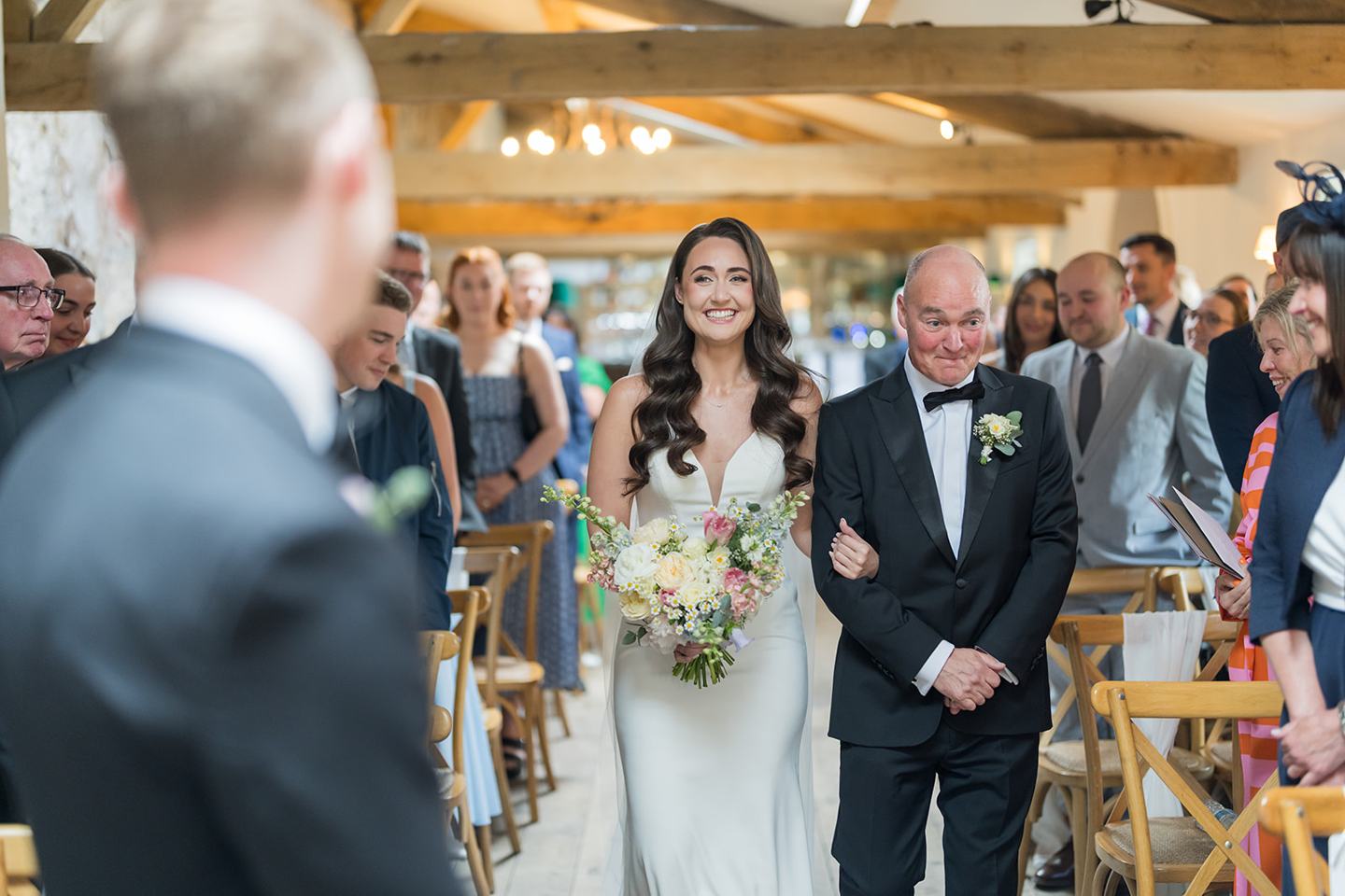 Bride arriving for the ceremony at Becky and Alex’s Middleton Lodge wedding