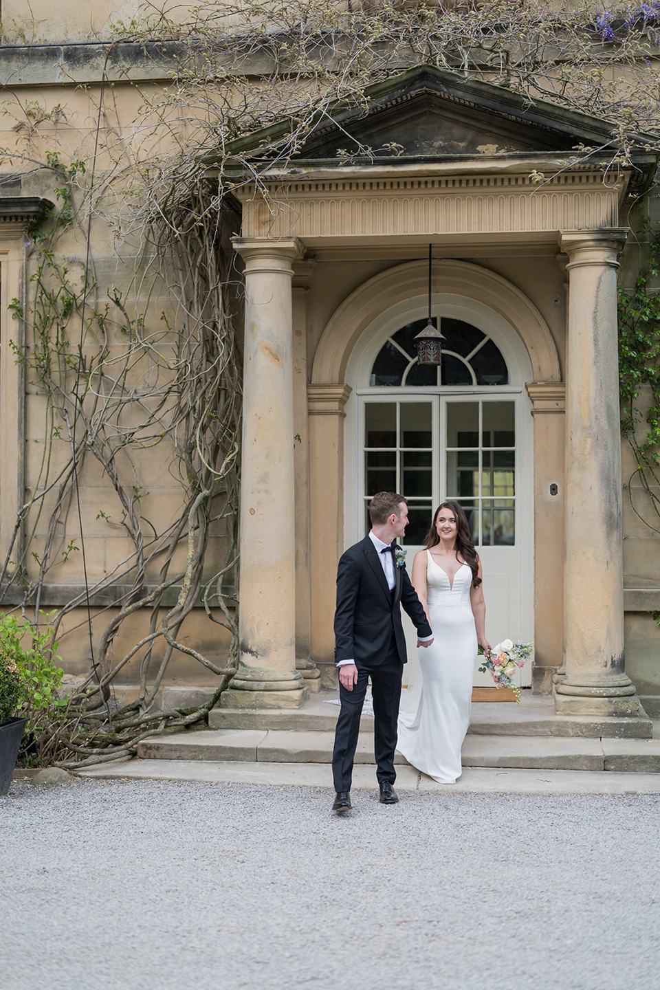 Couple outside the main house at Becky and Alex’s Middleton Lodge wedding