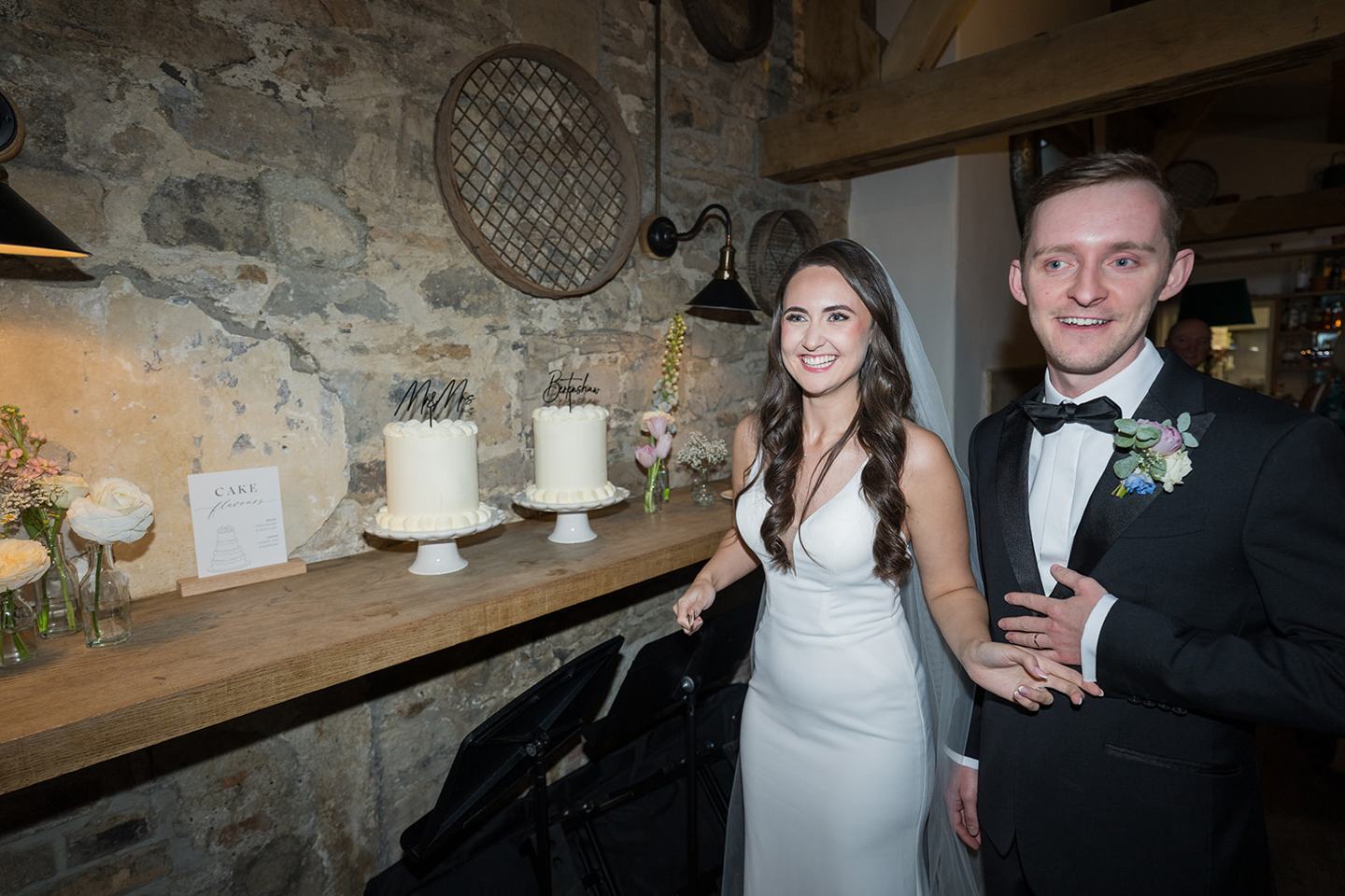 Cutting the cake at Becky and Alex’s Middleton Lodge wedding