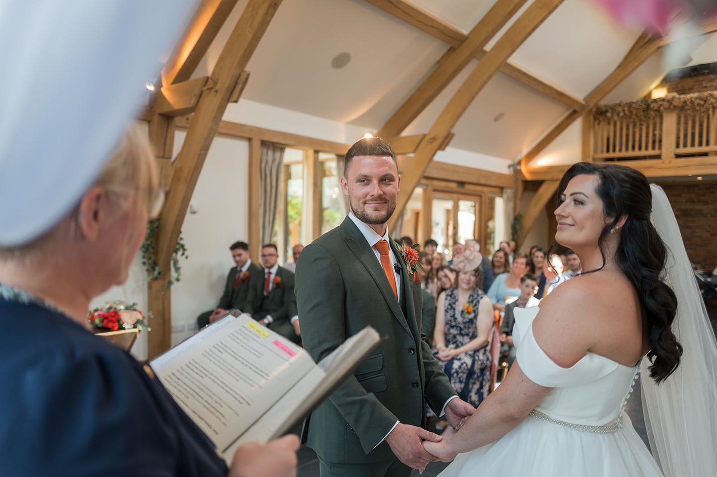 Couple exchanging vows at Kate and Kieran’s Mythe Barn wedding
