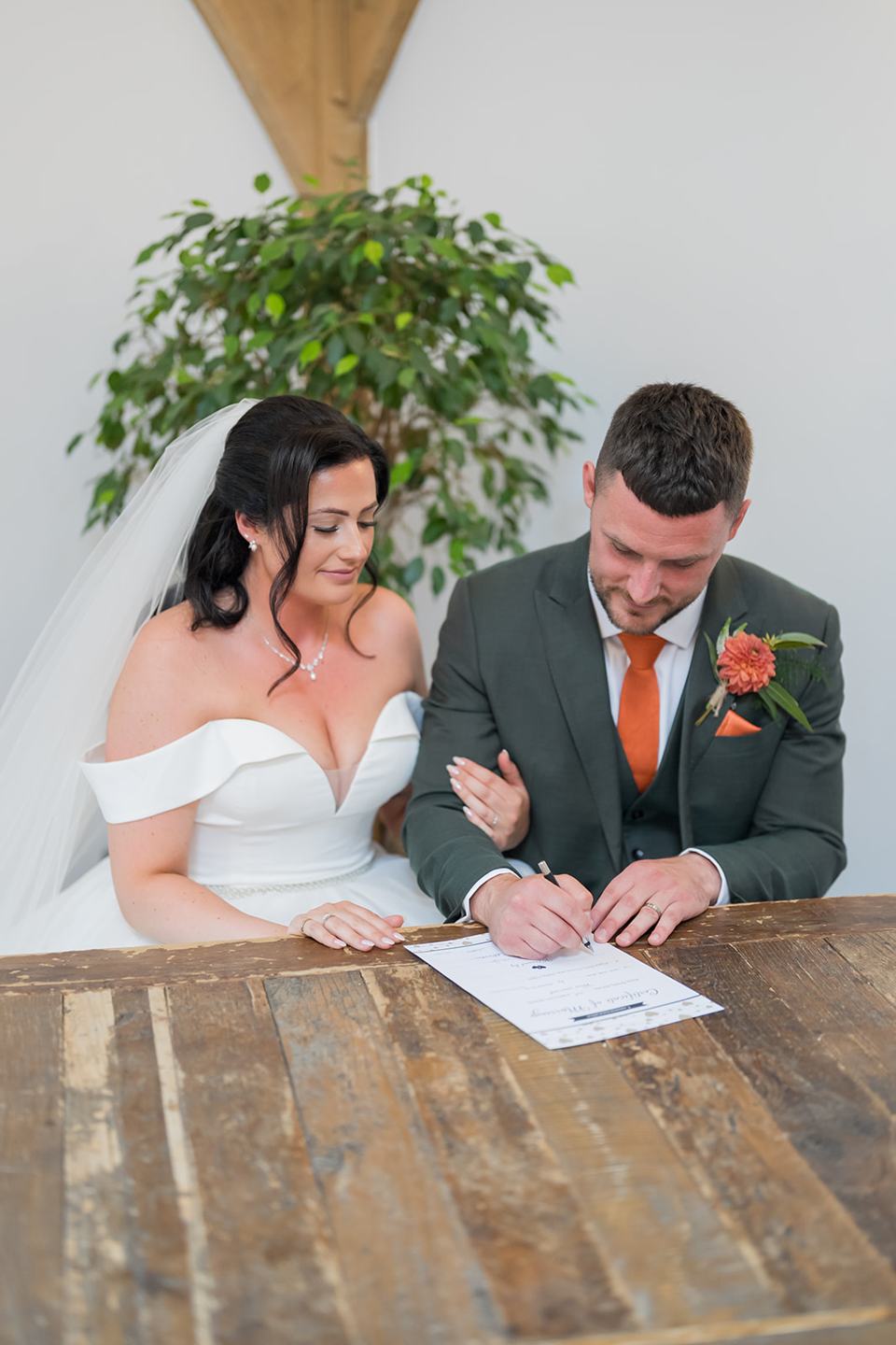 Signing the register at Kate and Kieran’s Mythe Barn wedding