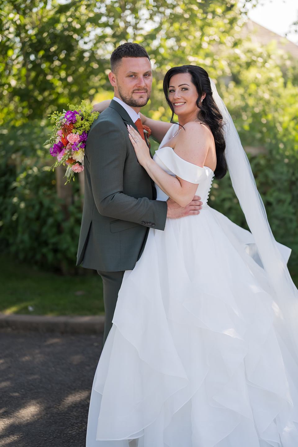 Couple portrait in the gardens at Kate and Kieran’s Mythe Barn wedding