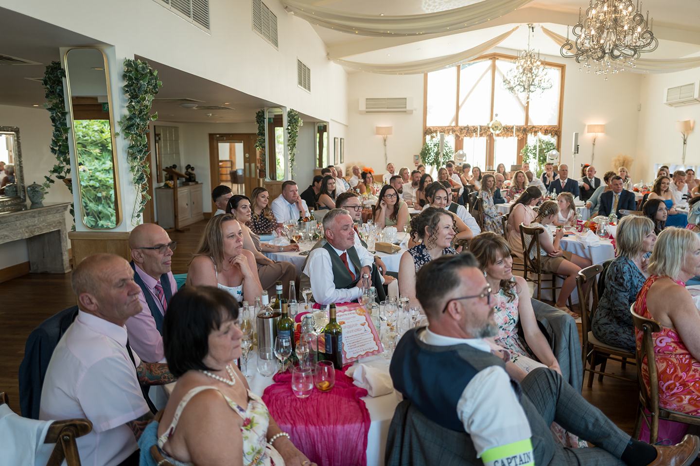 Guests enjoying the wedding speeches at Kate and Kieran’s Mythe Barn wedding