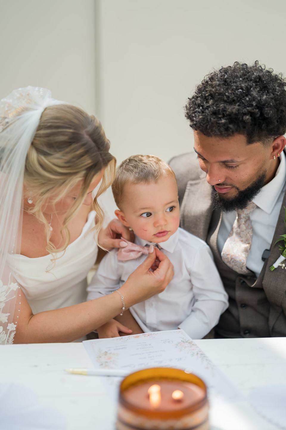 Newlyweds with their child at Kate and Jacob’s The Orangery at Ingestre wedding