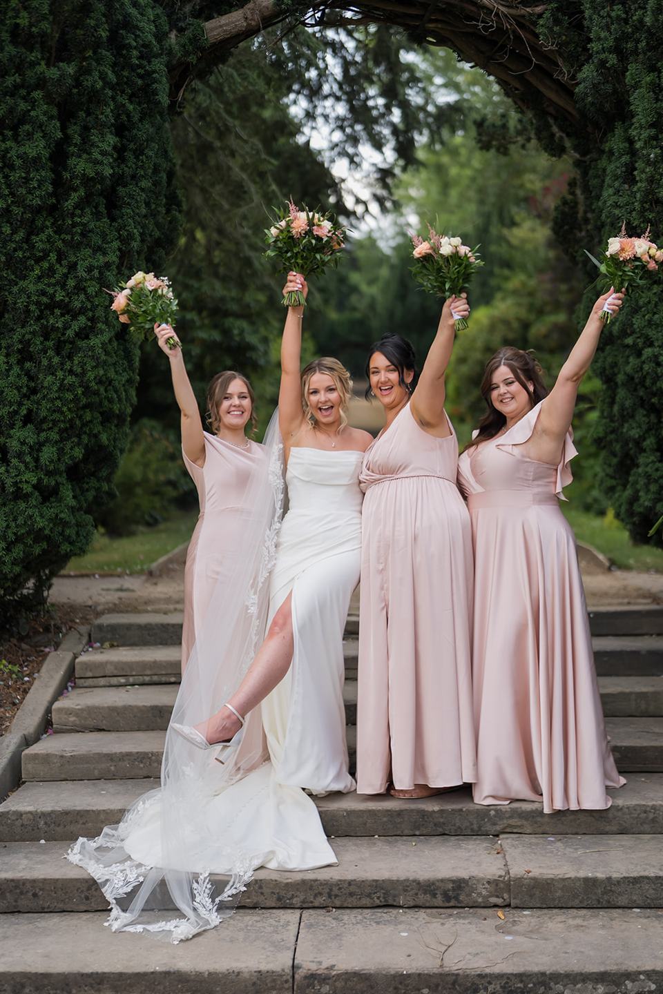 Bride celebrating with bridesmaids at Kate and Jacob’s The Orangery at Ingestre wedding