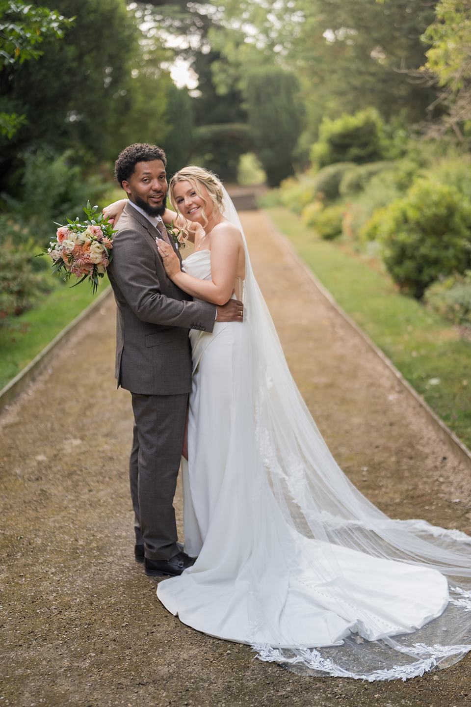 Couple portrait on the garden path at Kate and Jacob’s The Orangery at Ingestre wedding