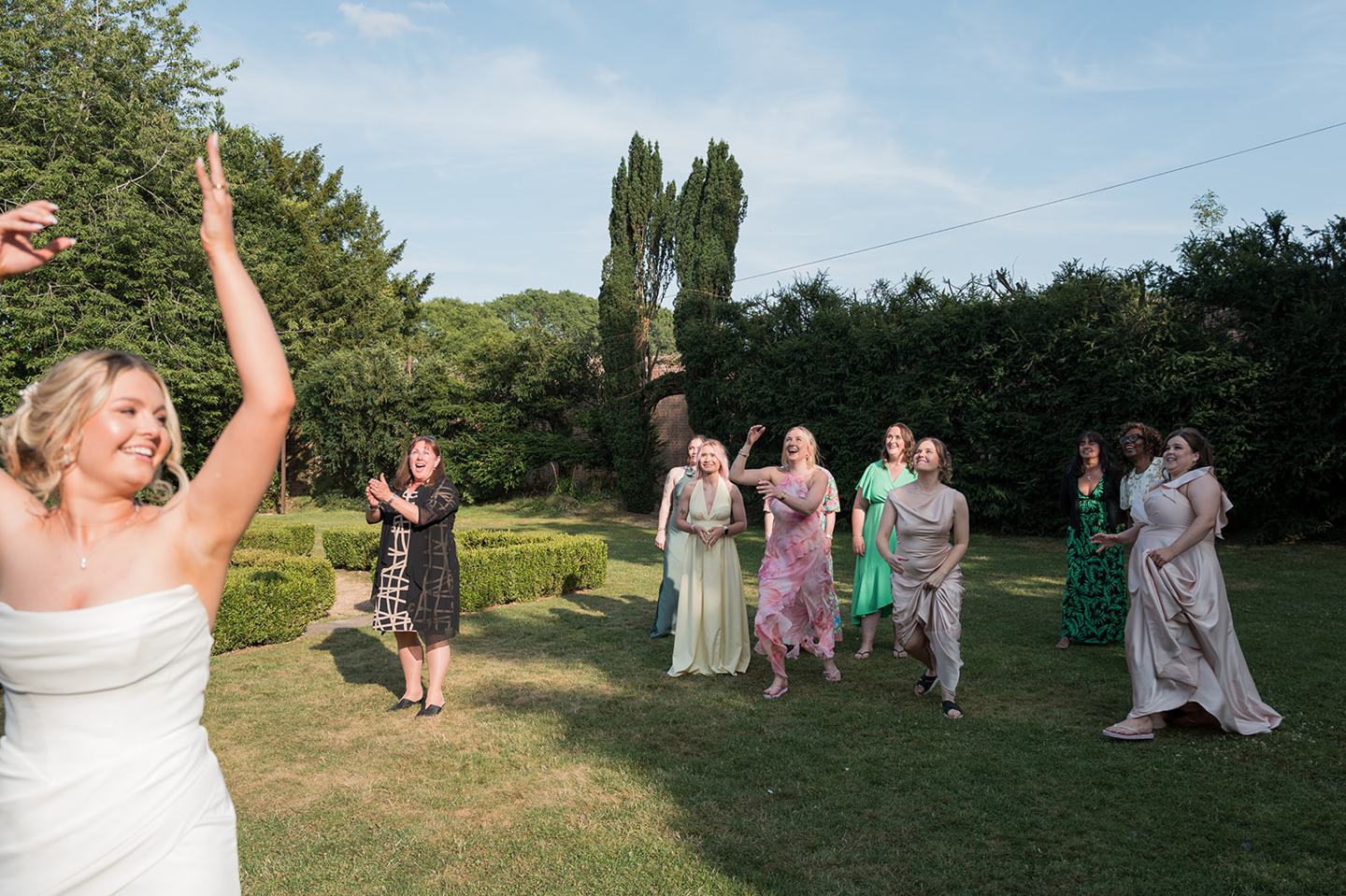 Bouquet toss in the gardens at Kate and Jacob’s The Orangery at Ingestre wedding