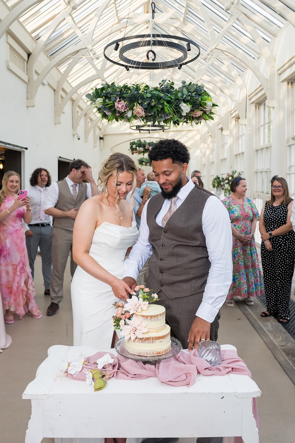 Cutting the wedding cake at Kate and Jacob’s The Orangery at Ingestre wedding