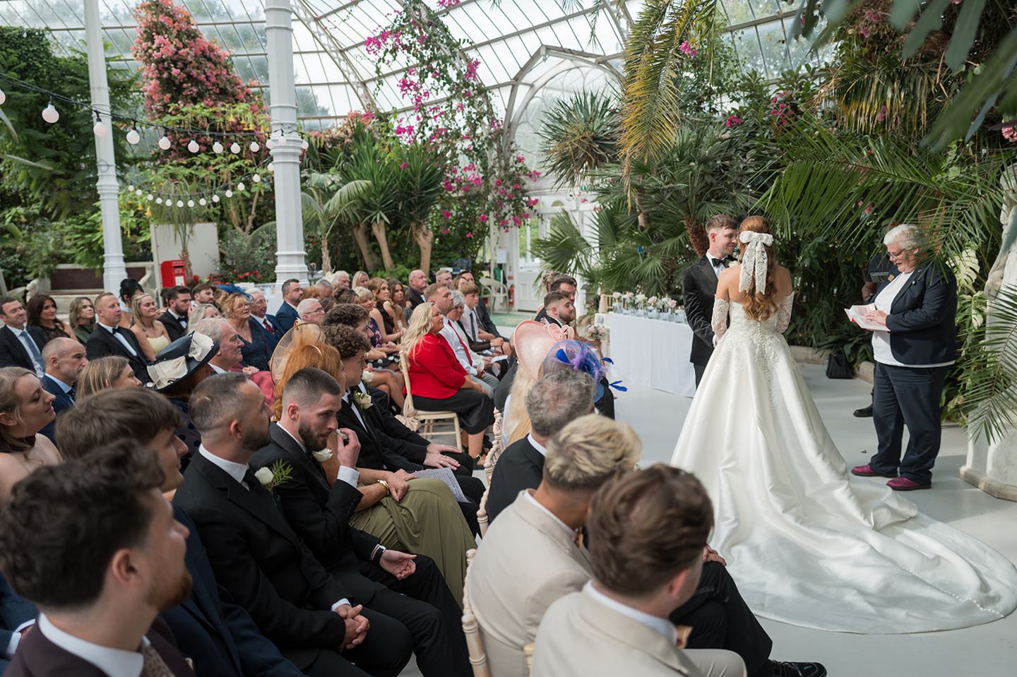 Guests at the ceremony at Heather and Charlie’s Sefton Park Palm House wedding