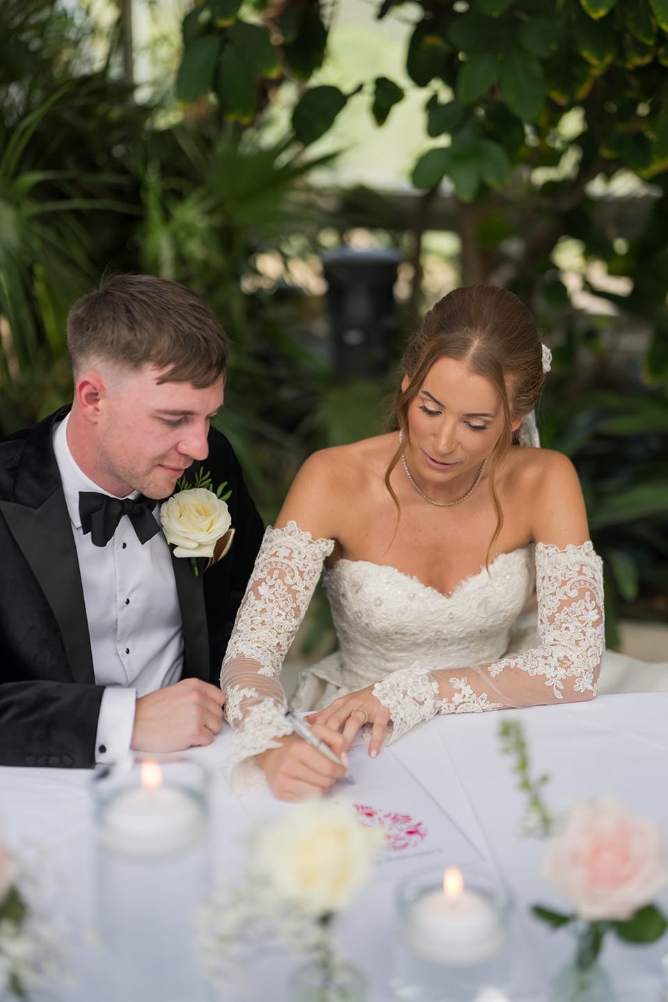 Signing the register at Heather and Charlie’s Sefton Park Palm House wedding